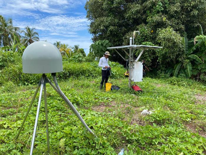 CGO scientist next to a GPS station from the SuGAr network (Source: Juniator Tulius/Earth Observatory of Singapore)