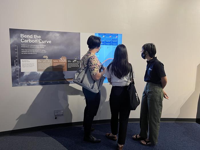 Visitors learn more about carbon emission impact models from EOS staff (Source: Cheryl Han/Earth Observatory of Singapore)