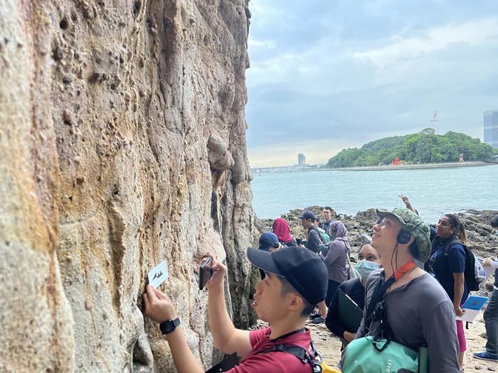 Teachers observing one of Tanjong Rimau’s rock formations (Source: Cheryl Han/Earth Observatory of Singapore)