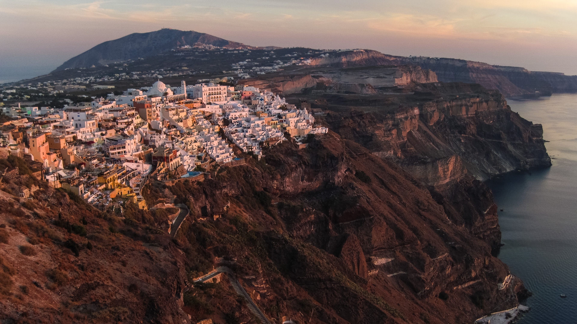 The town of Fira, overlooking the caldera. Each layer in the cliffs is the deposit from a different eruption of Santorini. (Source: Gareth Fabbro/Earth Observatory of Singapore)