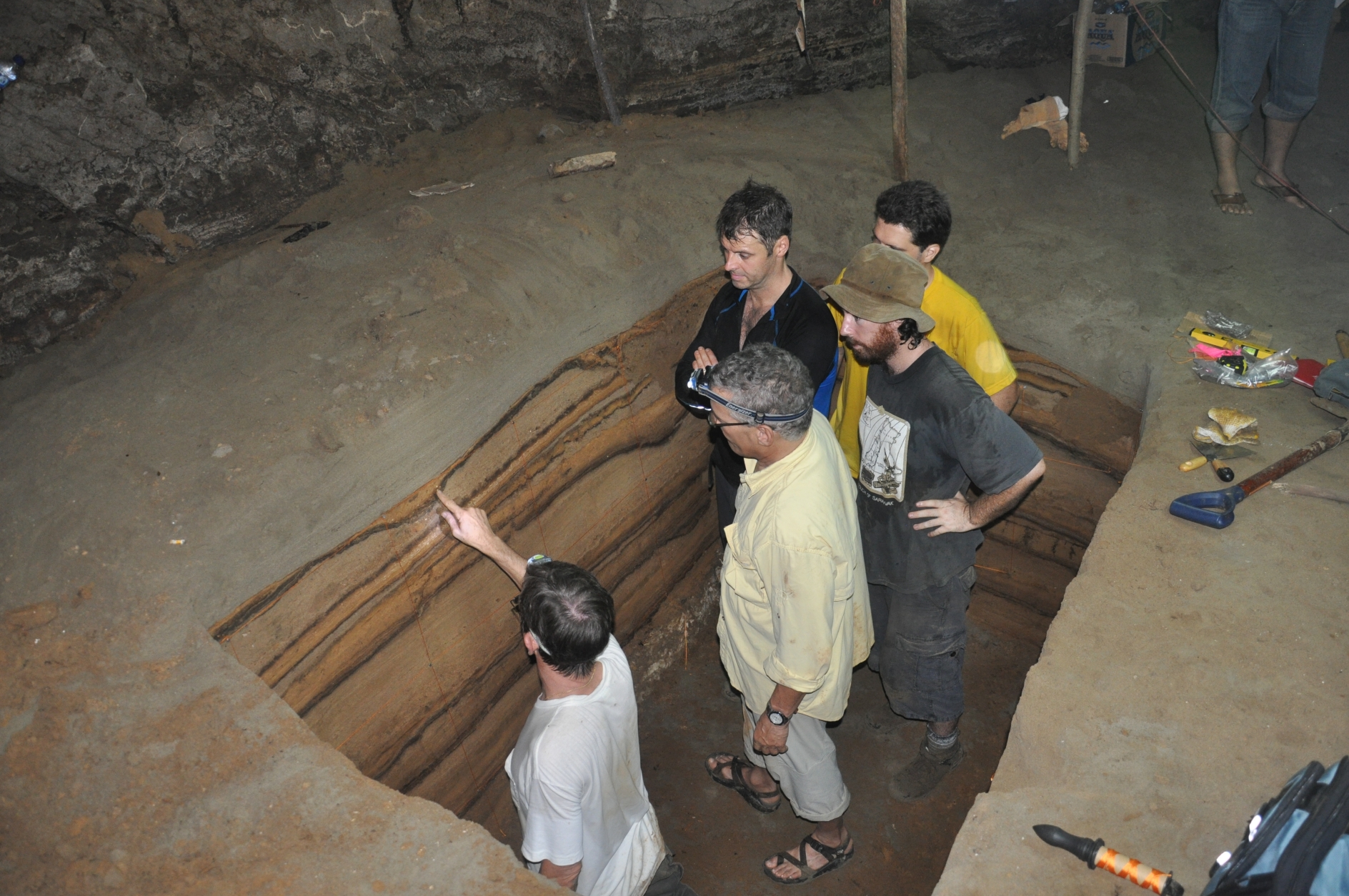 EOS Scientists studying the sequence of tsunami deposits along a trench in a cave, that produced a 7,600-year tsunami record (Source: Patrick Daly/Earth Observatory of Singapore)