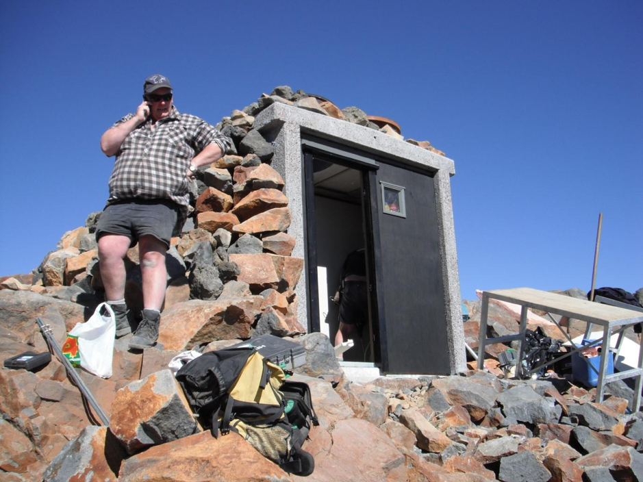 A layer of boulders now armour the roof and sides of a previously bare, reinforced concrete shelter near the summit of Mount Ruapehu in New Zealand. This effort was carried out by the nation’s Department of Conservation in an effort to increase the building’s impact resistance to projectile impacts and for the building to blend in better with its surroundings (Source: Harry Keys/New Zealand’s Department of Conservation)  