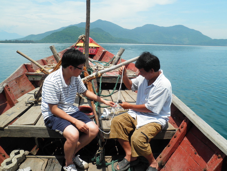Scientist Dr Pham Tien Dat (left) and the boat captain during offshore sampling outside of Lap An Lagoon (Source: Chris Gouramanis /Australian National University)
