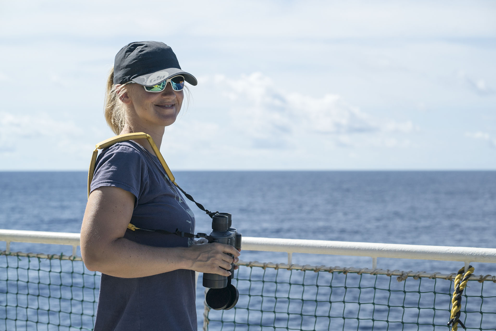 Dr Rebecca Jewell observes the horizon in search for any kind of indication of marine mammals around the ships, while the air-guns are being ramped up (Source: EOS/ Monika Naranjo Gonzales)
