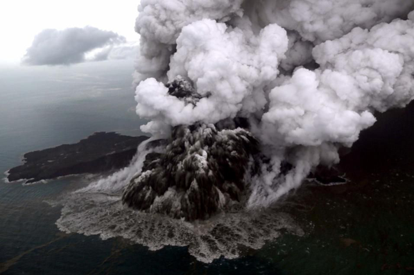 This aerial picture shows the Anak Krakatau volcano erupting from its flank on 23 December 2018 (Source: Nurul Hidayat/AFP/Getty Images)