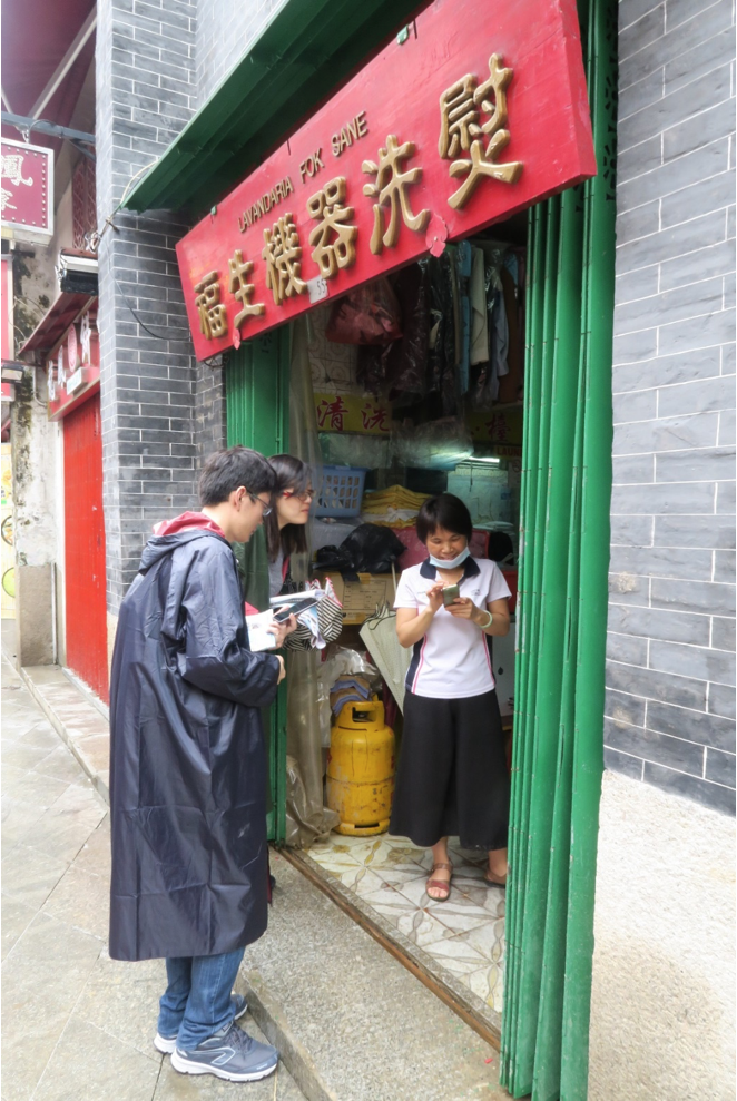 Dr Linlin Li (EOS) and Dr Kuifeng Zhao (NUS) conduct an interview with a shop owner in Macau, who provided the team with video evidence of the flooding during Typhoon Hato (Source: Constance Chua)